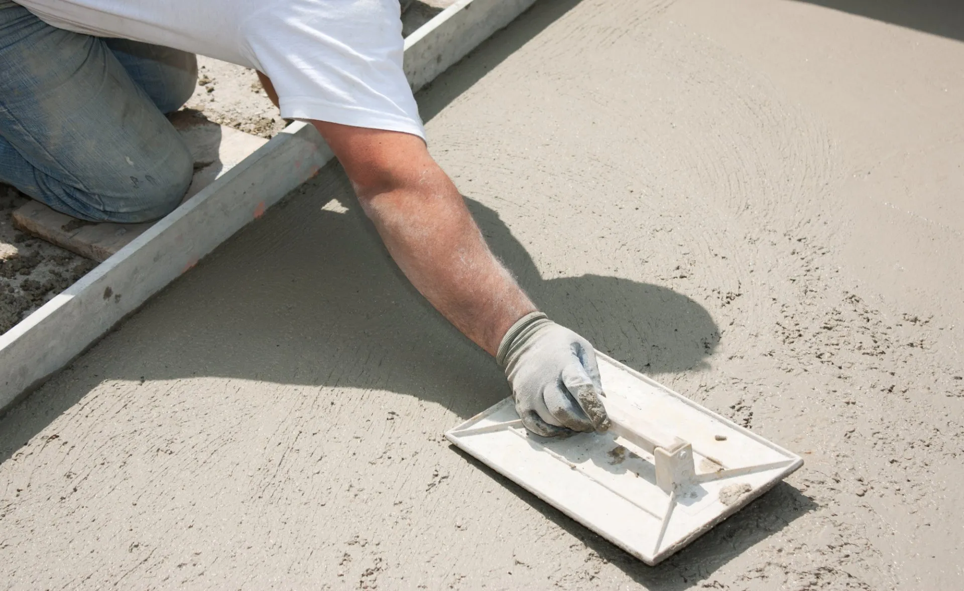 Golden Gate FL contractor using bullnose flooring trowel to level the concrete surface
