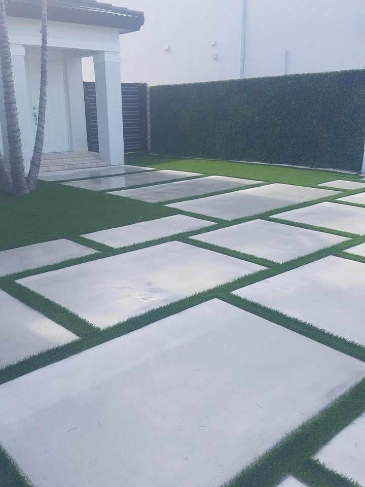 artificial grass installed between paved concrete driveway in Naples FL